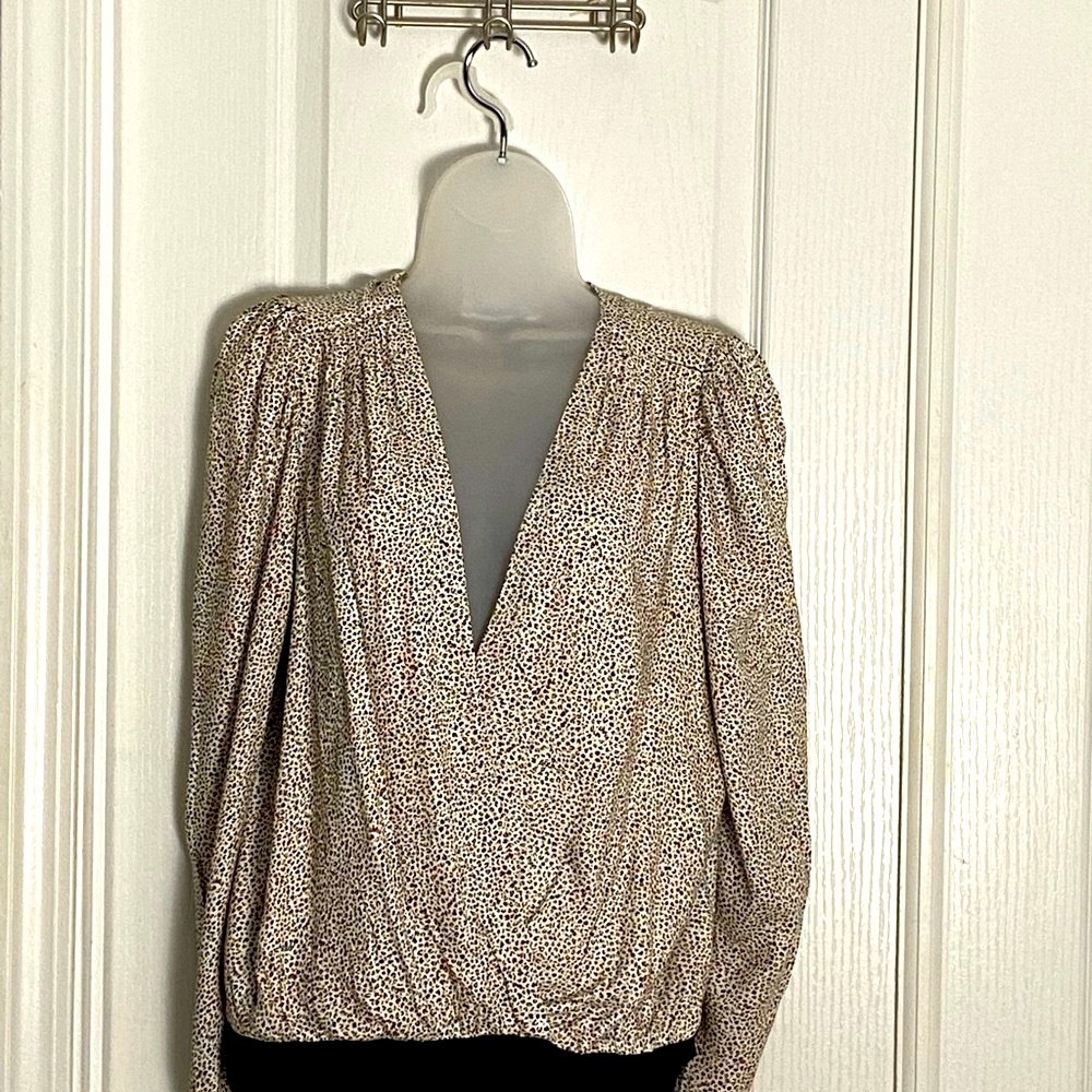 Long sleeve pleated shoulder deep V bodysuit.